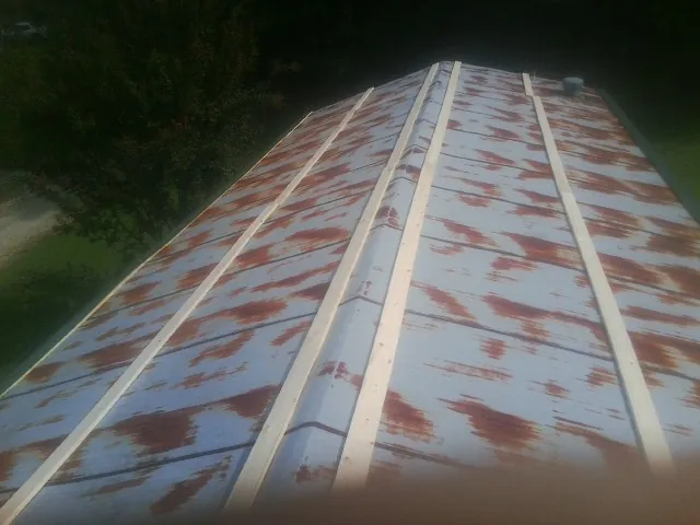 Rusted metal roof panels with new wood purlins before replacement — Storm Damage Roof Repair in Frankton by Roofing Brothers